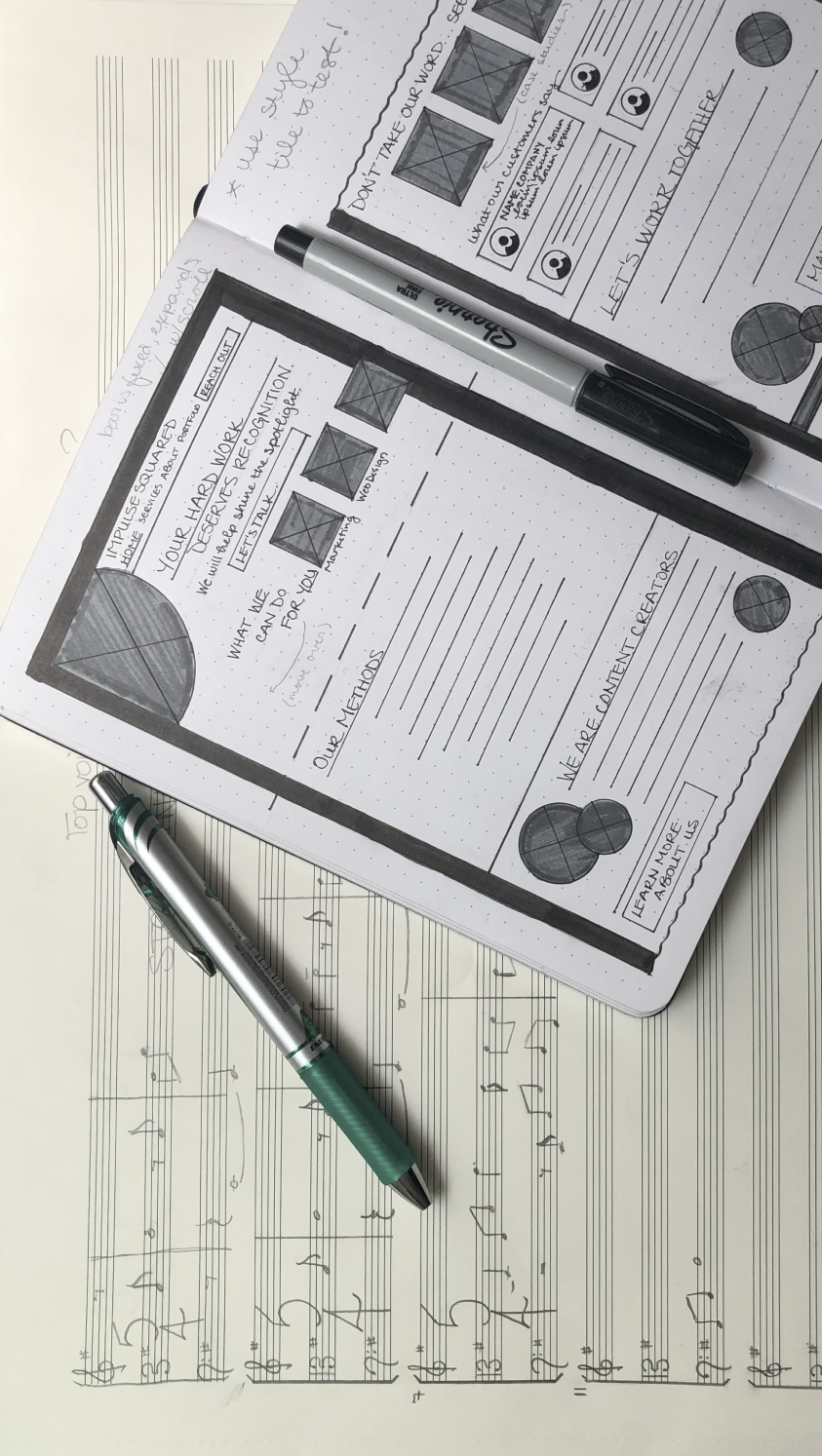 Handwritten sheet music and wireframe sketches side by side
